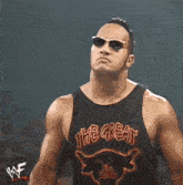 a man wearing sunglasses and a tank top that says the great on it