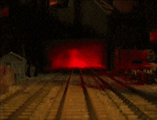 two cartoon trains are on a train track with a red light in the background