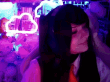 a girl with pigtails is standing in front of a cloud neon sign