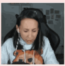 a woman is sitting in a chair wearing headphones .