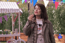 a woman standing in front of a cart that says nagore robles influencer on it