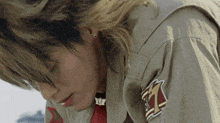 a close up of a person wearing a jacket with a patch on the sleeve that says tz