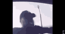 a man in a baseball cap is holding a golf club in his hand .