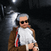 a man wearing a wig and sunglasses is standing in the dark