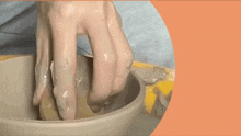 a person is playing with clay in a bowl and the words outstand absorb are visible