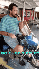 a man is sitting on a motorcycle with the words so chez siffle written below him