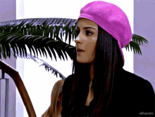 a woman wearing a pink hat with editsmaite written on the bottom right