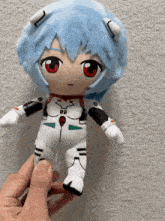 a person is holding a stuffed toy with a red eye