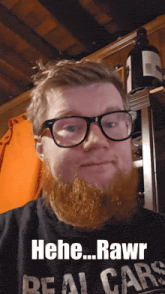 a man with glasses and a beard is wearing a shirt that says " real cars "