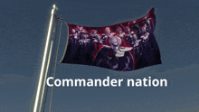 a commander nation flag flies in the wind against a blue sky