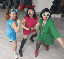 three women are posing for a picture and one of them is wearing a green shirt