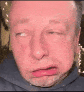 a close up of a man 's face with a beard making a funny face .