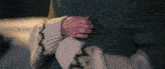 a person in a sweater is hugging another person .