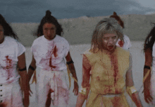 a woman with blood on her face has the number 11 painted on her cheek