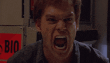 a man is screaming in front of a sign that says bio on it