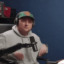 a man wearing headphones and a green hat with a circle on it