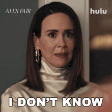 a woman says i don 't know while wearing a white top