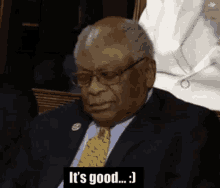 a man in a suit and tie is sitting in a row and saying it 's good .