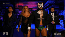 a group of wrestlers are walking in a dark room with usa written on the bottom right