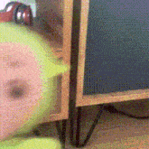 a blurred image of a person standing next to a wooden cabinet