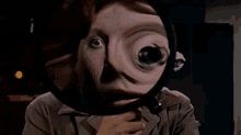 a woman is looking through a magnifying glass at herself