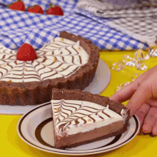 a person is taking a slice of pie from a white plate