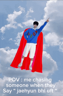 a man with a red cape is flying through the sky