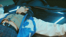 a person laying on the hood of a car