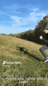 a man is jumping in the air while running down a grassy hill .