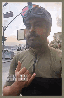 a man wearing a helmet and goggles is giving a thumbs up