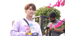 a young man wearing a purple shirt that says nice girl
