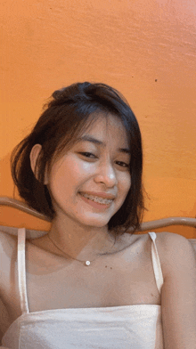 a girl with braces on her teeth is smiling
