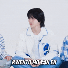 a person sitting on the floor with the words kwento mo yan eh written above them