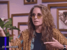a woman wearing sunglasses has the hashtag lialmeida05 at the bottom of her photo