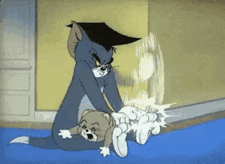 tom and jerry are playing with each other on a blue mat