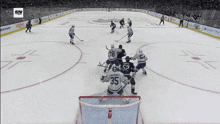 a hockey game is being played and the goalie has the number 35 on the back of his jersey