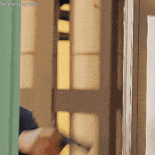 a person is standing in front of a door with the word kevserpayasli written on the bottom