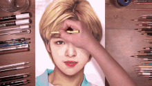 a person is drawing a woman 's face with a pencil that says uni