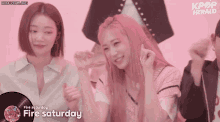 two girls with pink hair are dancing in front of a kpop herald advertisement
