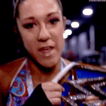 a close up of a woman holding a championship ring