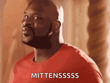 a bald man with a beard is wearing a red shirt and saying mittensssss .