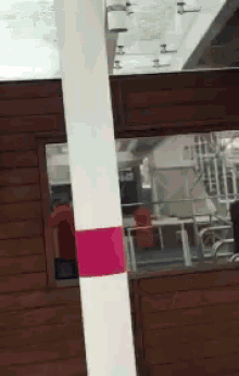 a white pole with a pink stripe on the bottom