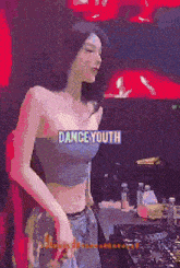 a woman in a crop top with the word dance youth on it