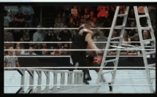a ladder is in the middle of a boxing ring