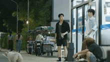 a man standing in front of a store with a bottle in his hand