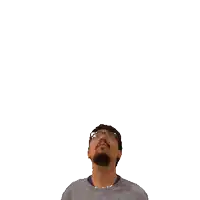 a man with glasses and a beard looks up at a green cross on his head