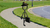 a stick figure with a hat and a briefcase is walking down a sidewalk