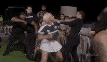 a group of people are fighting each other on a field .