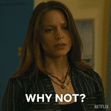 a woman with a necklace says why not