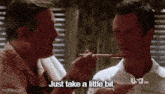 two men are eating with chopsticks and one man says just take a little bit